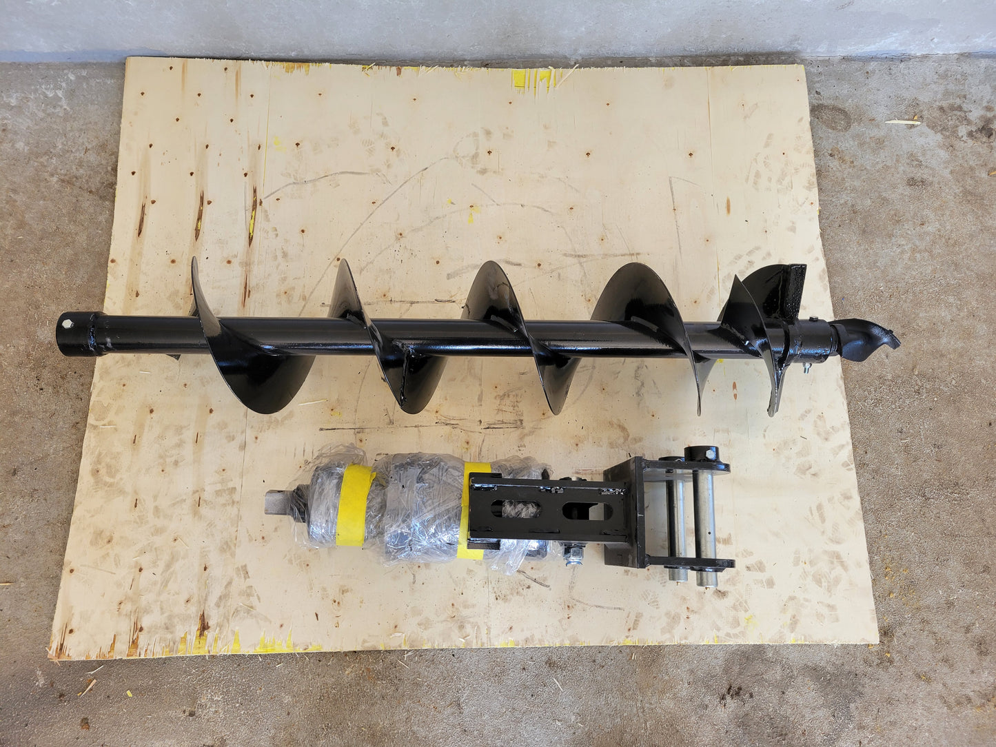Top view of hydraulic auger attachment for excavators by JoyT5, heavy-duty earth drilling equipment.