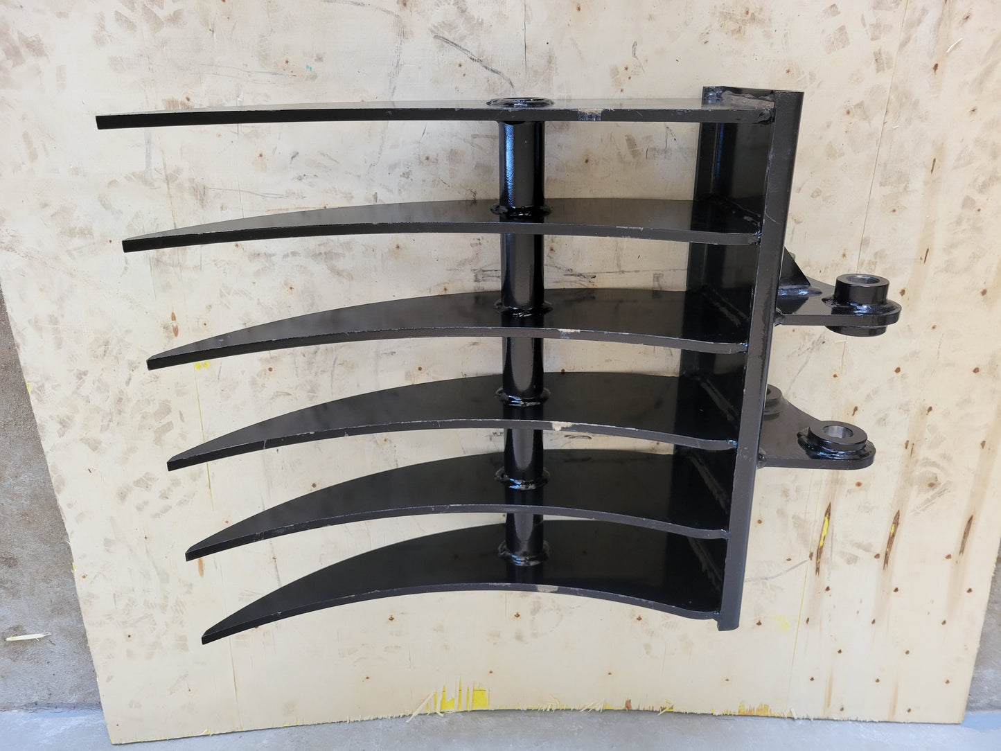 Side view of mini excavator rake attachment for sale in Calgary, Canada – heavy duty JoyT5 excavator rake tool for landscaping, construction, and land clearing; built for durability and precision.