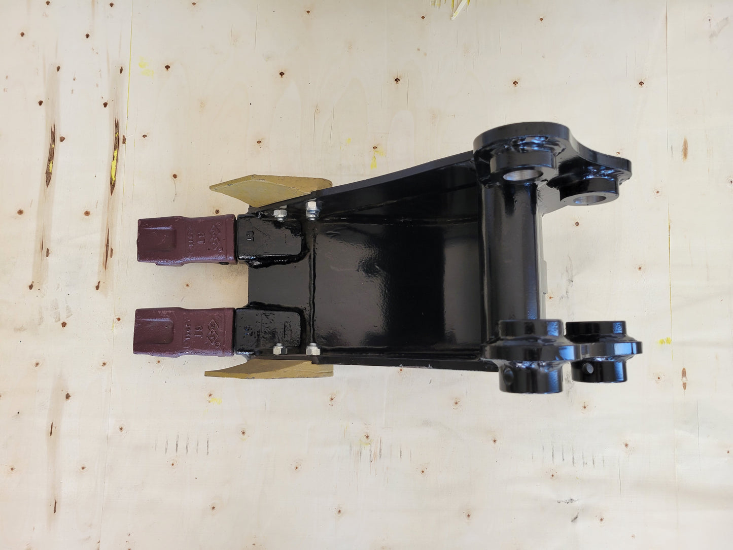 Mini excavator trenching bucket attachment top view showing twin cutting teeth and reinforced steel frame for digging and drainage work in Canada