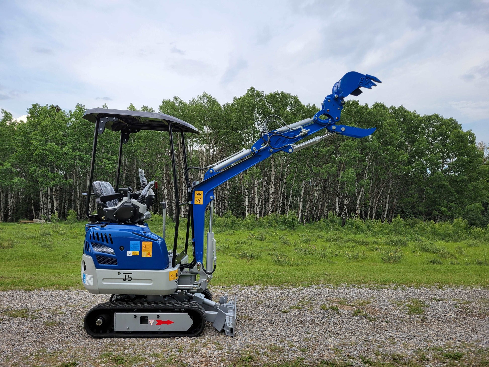 1.2 ton mini excavator lifting arm 
outdoors in Calgary Canada compact machine rental for landscaping and 
construction projects in Alberta

