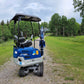 1.2 ton mini excavator parked on gravel path surrounded by green field available for rent in Calgary Alberta for small landscaping and construction projects


