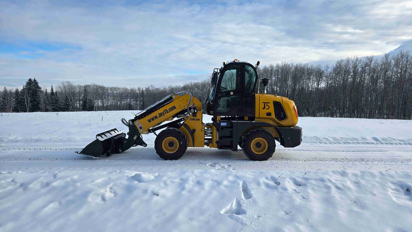 1.5 ton compact wheel loader parked on snowy work site in Canada ideal for construction farms and material handling operations

