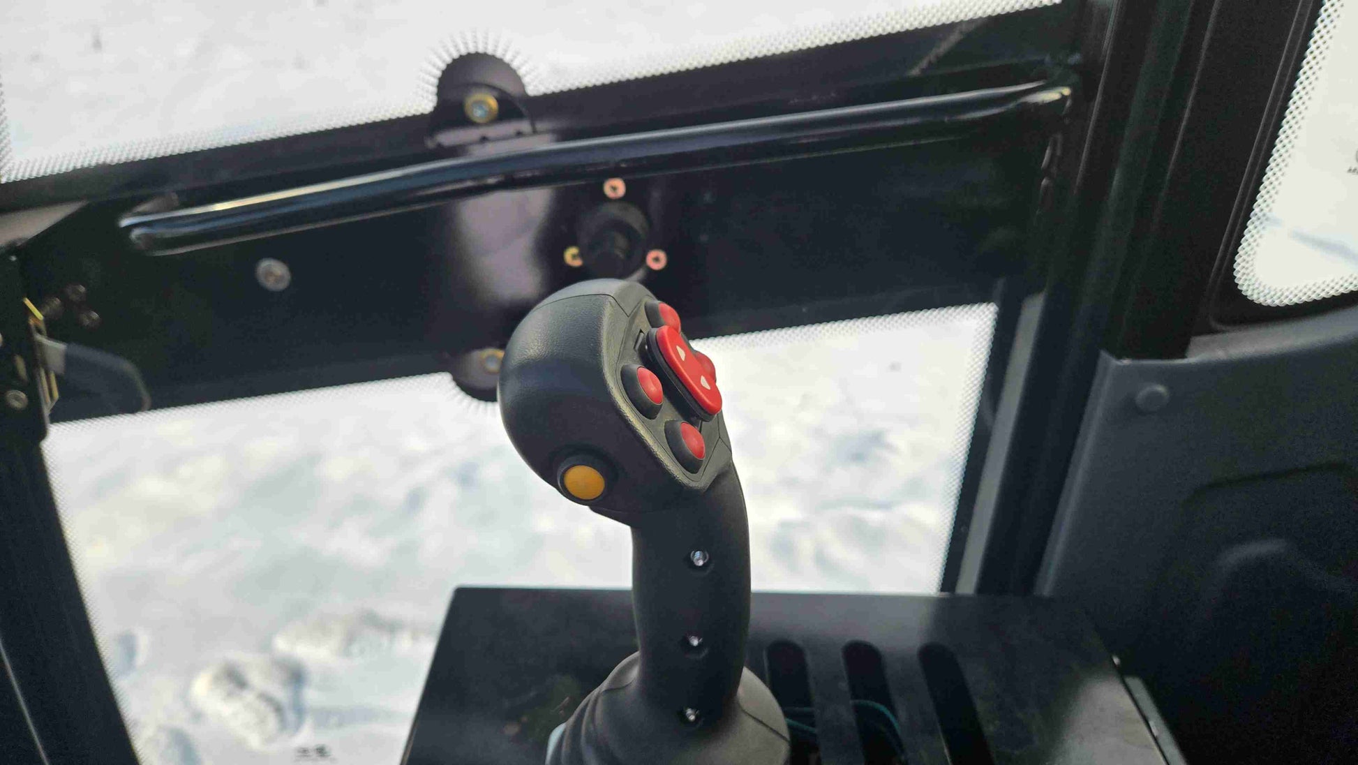 joystick control of 1.5 ton compact wheel loader showing ergonomic grip and control buttons inside the cabin in Canada