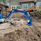 JoyT5 1.2-ton mini excavator rental in Calgary, Alberta, compact excavator digging and leveling soil on a residential landscaping project in Canada.