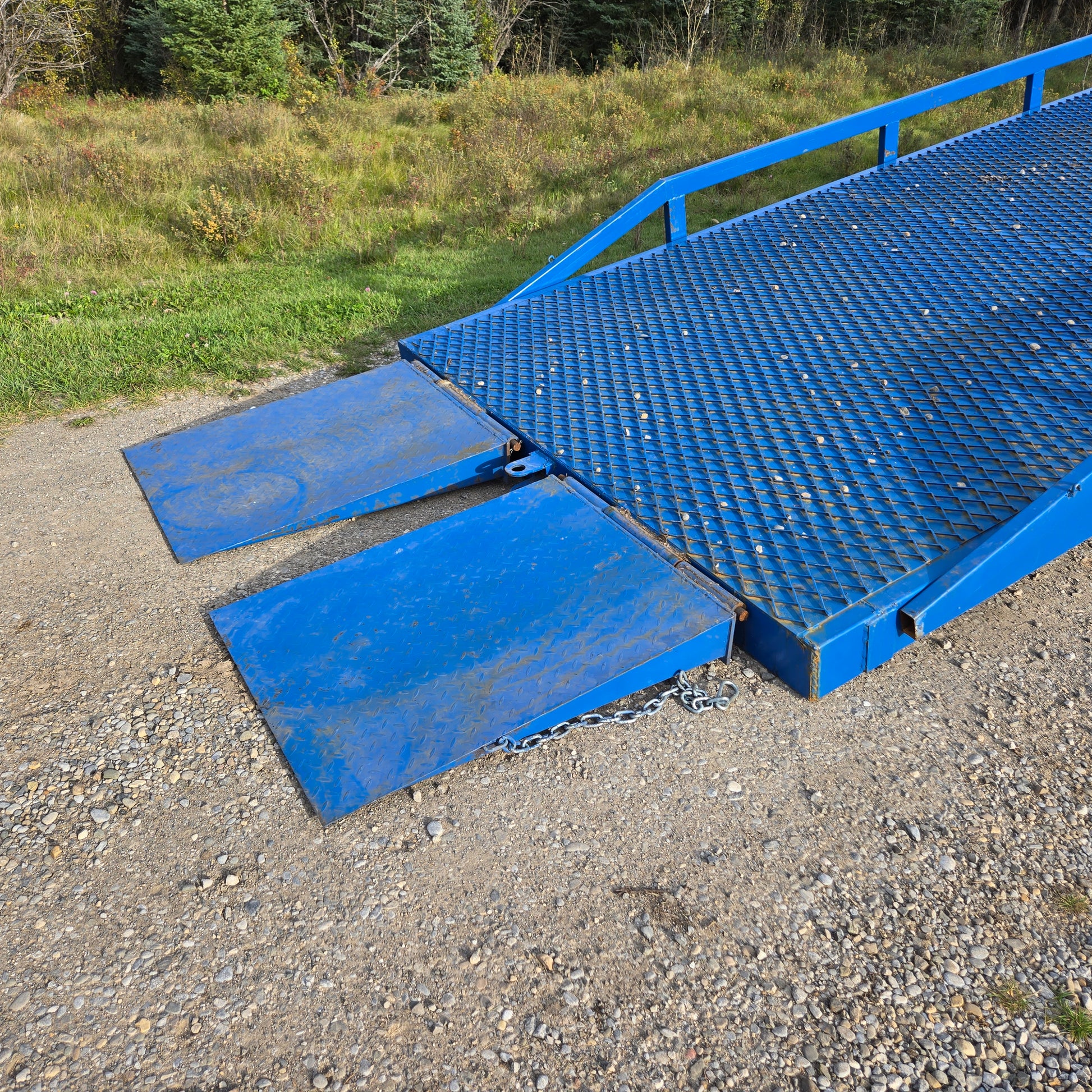 Twelve ton mobile loading ramp entry section showing heavy duty blue steel platform with grip plates for forklift and truck loading in Canada

