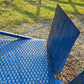 Close up view of twelve ton mobile loading ramp showing blue steel grip surface and end plate used for forklift and truck loading in Canada
