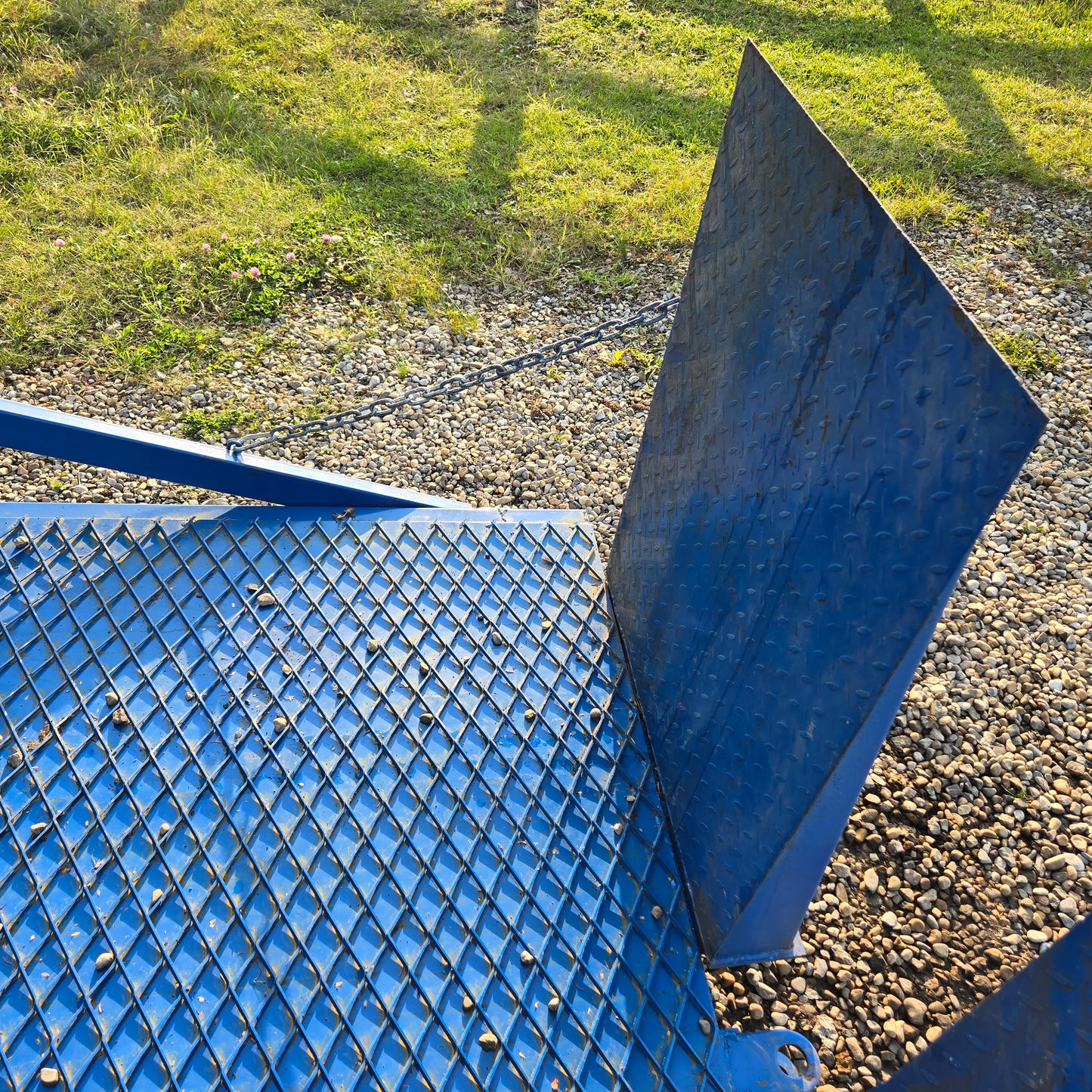 Close up view of twelve ton mobile loading ramp showing blue steel grip surface and end plate used for forklift and truck loading in Canada
