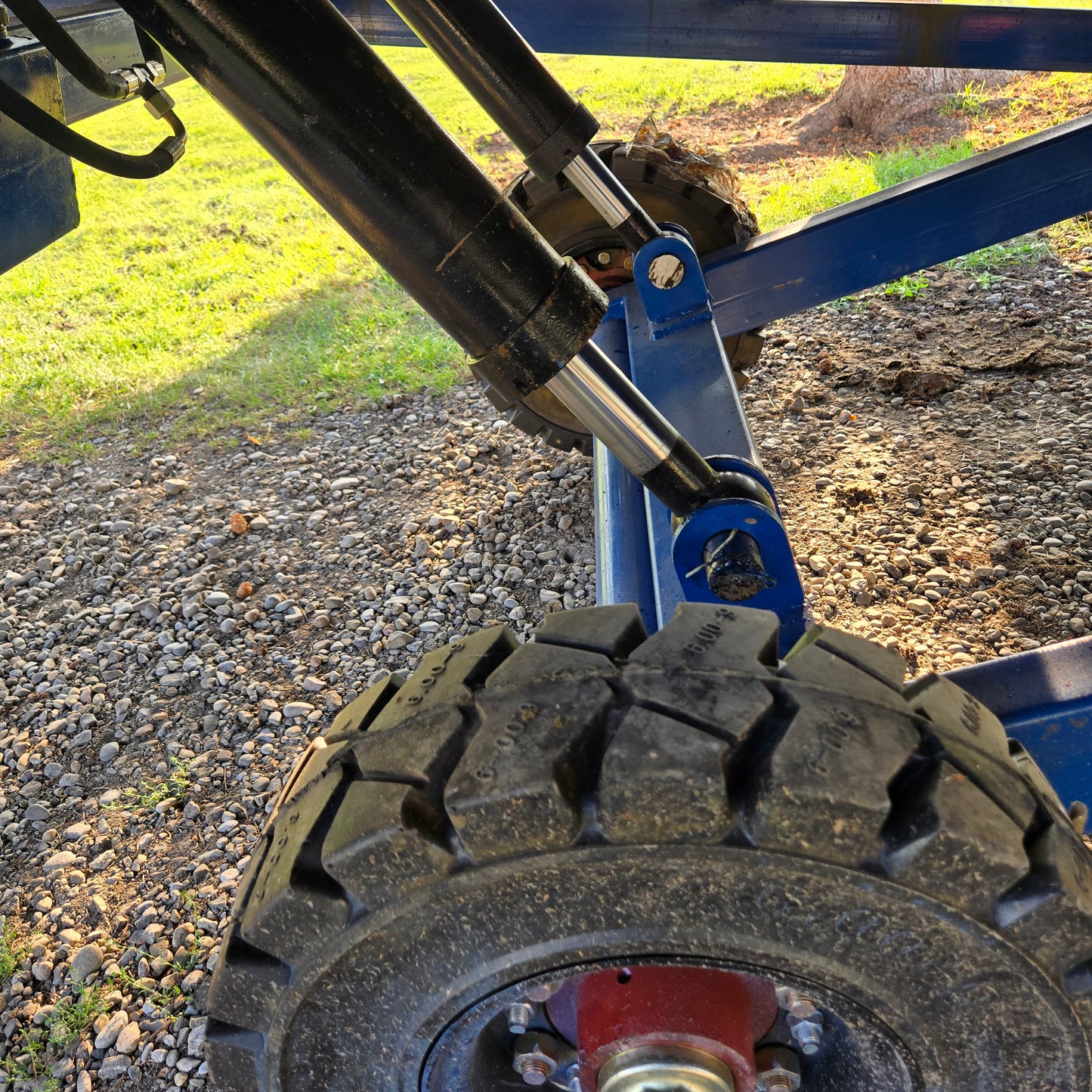 Close up view showing hydraulic cylinder and heavy tire system of twelve ton mobile loading ramp used for forklift and truck loading in Canada

