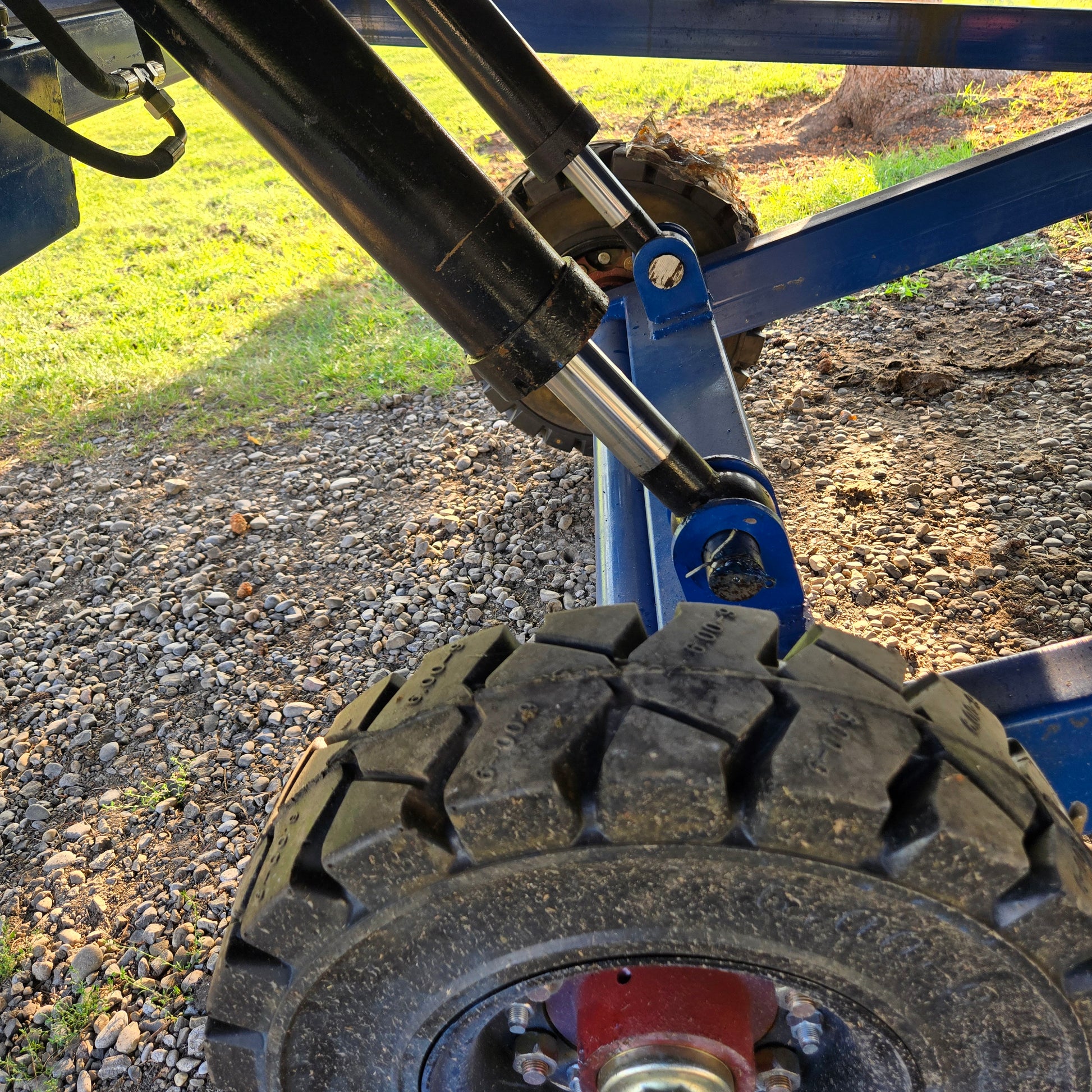 Close up view showing hydraulic cylinder and heavy tire system of twelve ton mobile loading ramp used for forklift and truck loading in Canada

