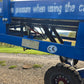Close up view showing blue steel hydraulic frame and heavy duty wheel system of twelve ton mobile loading ramp for forklift and truck in Canada


