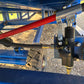Close up view showing hydraulic valve control system with red handle and hose connection under blue mobile loading ramp for forklift use in Canada

