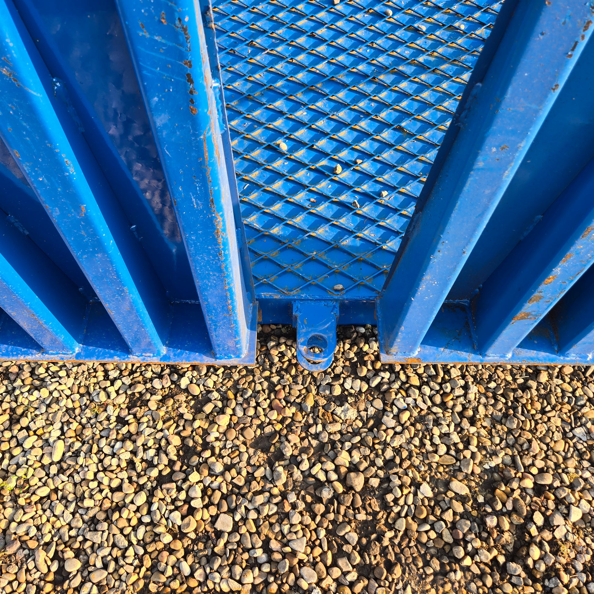 Close up view of twelve ton mobile loading ramp showing blue steel grip surface and attachment point for forklift loading in Canada


