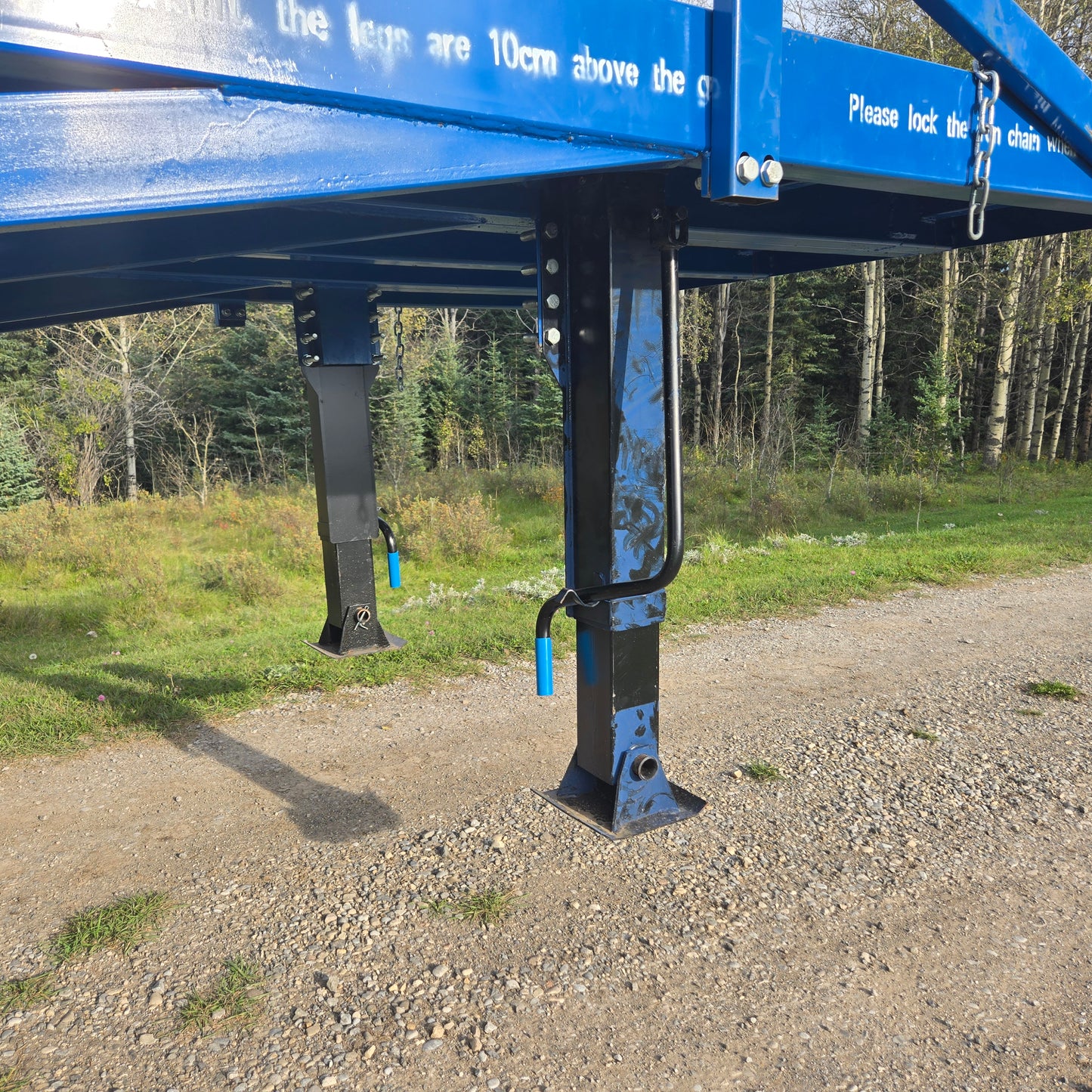 Close up view of twelve ton blue steel mobile loading ramp support leg showing adjustable height mechanism and sturdy frame for truck loading in Canada
