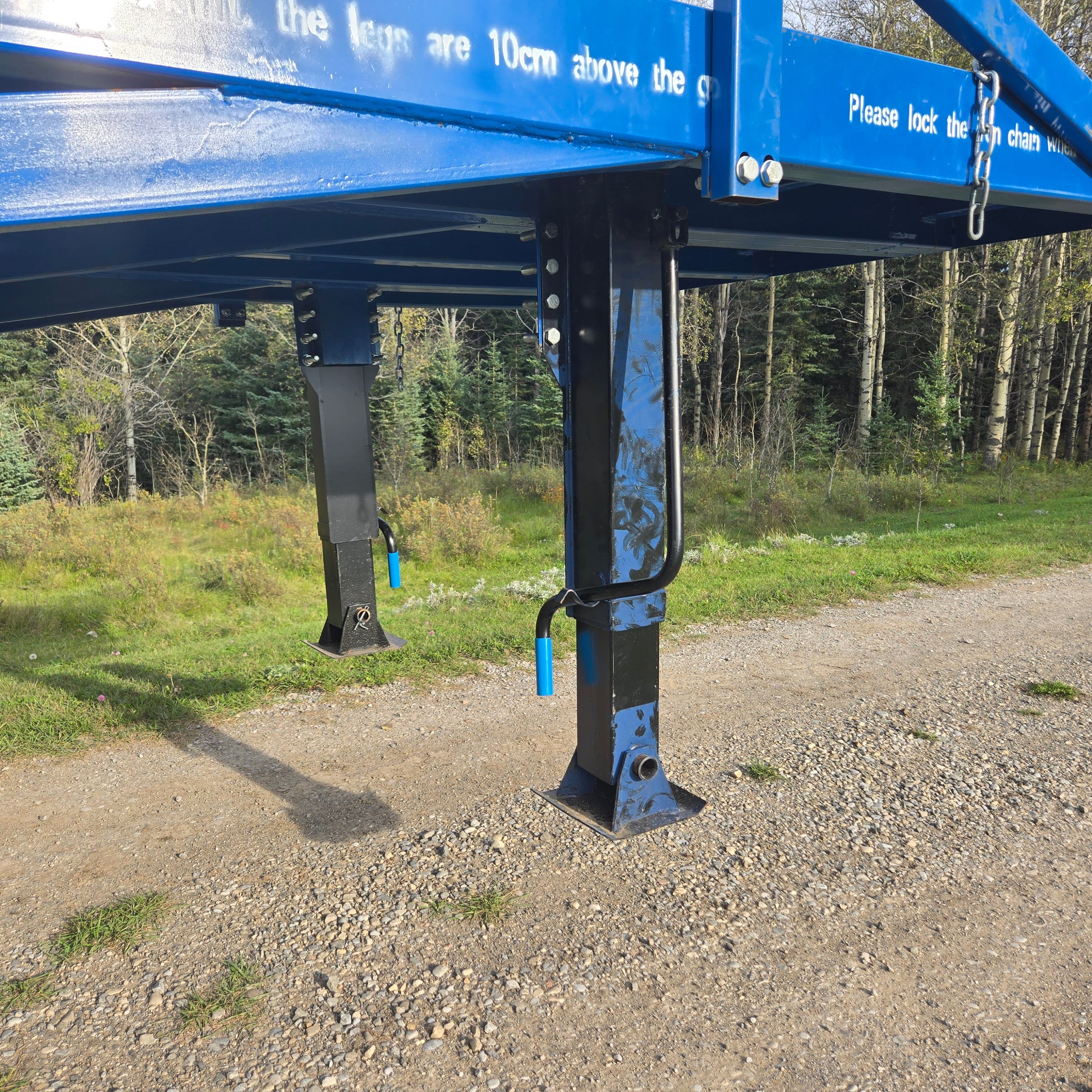 Close up view of twelve ton blue steel mobile loading ramp support leg showing adjustable height mechanism and sturdy frame for truck loading in Canada
