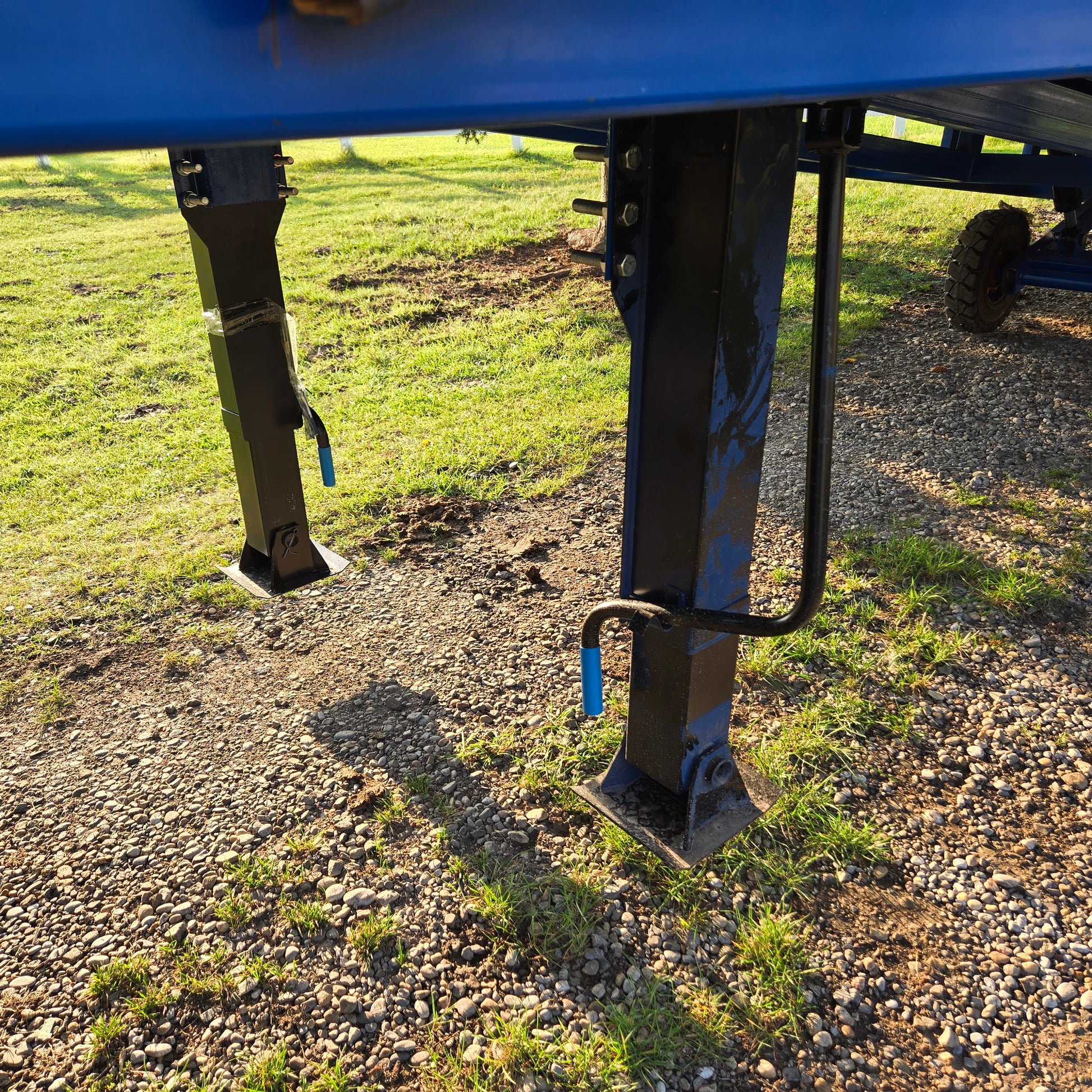 Close up view of twelve ton mobile loading ramp support leg showing blue steel adjustable base for stable forklift and truck loading in Canada

