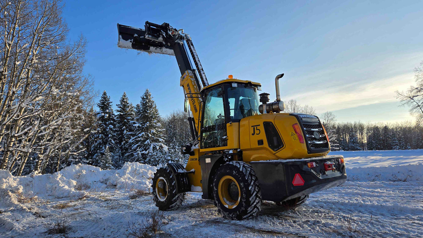 2.5 ton compact telescopic wheel loader lifting bucket high in snowy field in Canada powered by Cummins engine designed for construction and snow clearing work