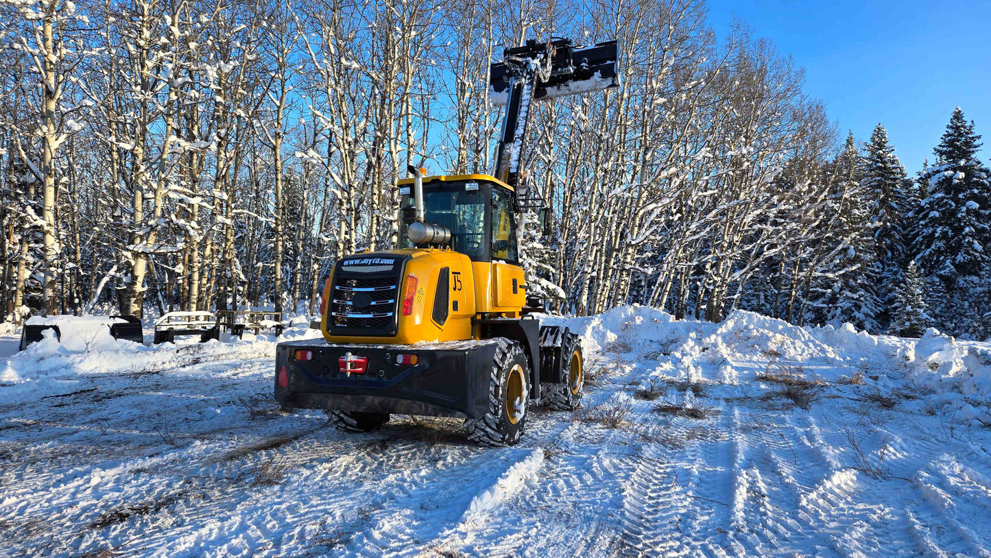 2.5 ton compact wheel loader with telescopic arm raised working in snowy construction site in Canada powered by Cummins engine for snow removal and heavy lifting