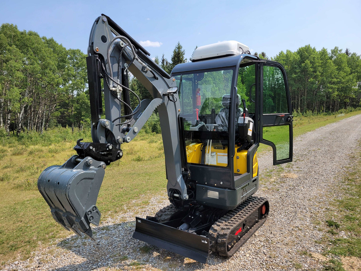 2 ton full cab mini excavator ready for rent in Calgary Alberta compact excavation machine ideal for landscaping and small construction projects


