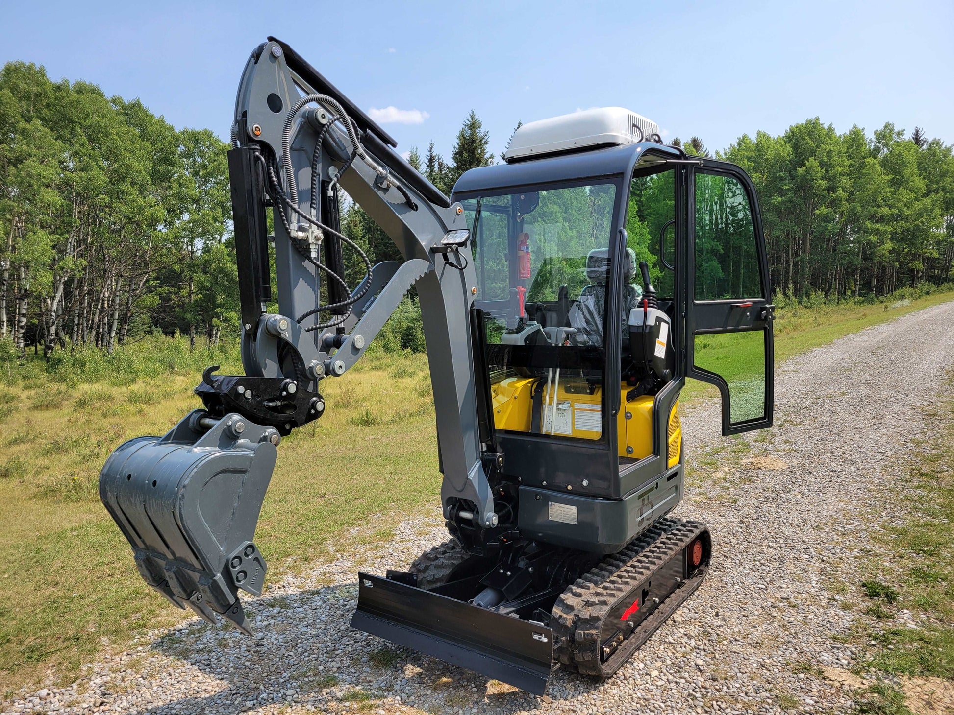 2 ton full cab mini excavator ready for rent in Calgary Alberta compact excavation machine ideal for landscaping and small construction projects


