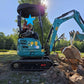 JoyT5 JT5200 2 ton mini excavator for rent in Calgary, Alberta compact excavator lifting rocks during a landscaping and digging project in Canada.

