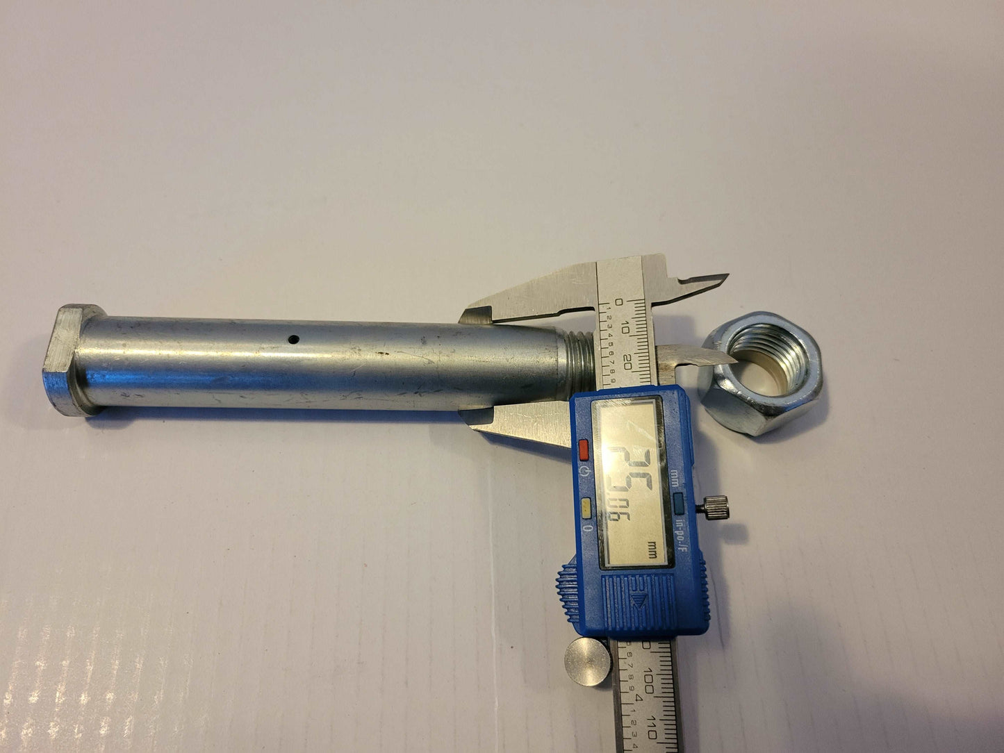 25 millimeter mini excavator bucket pin measured with digital caliper showing exact pin size for Agrotk and FF Industrial replacement parts in Canada