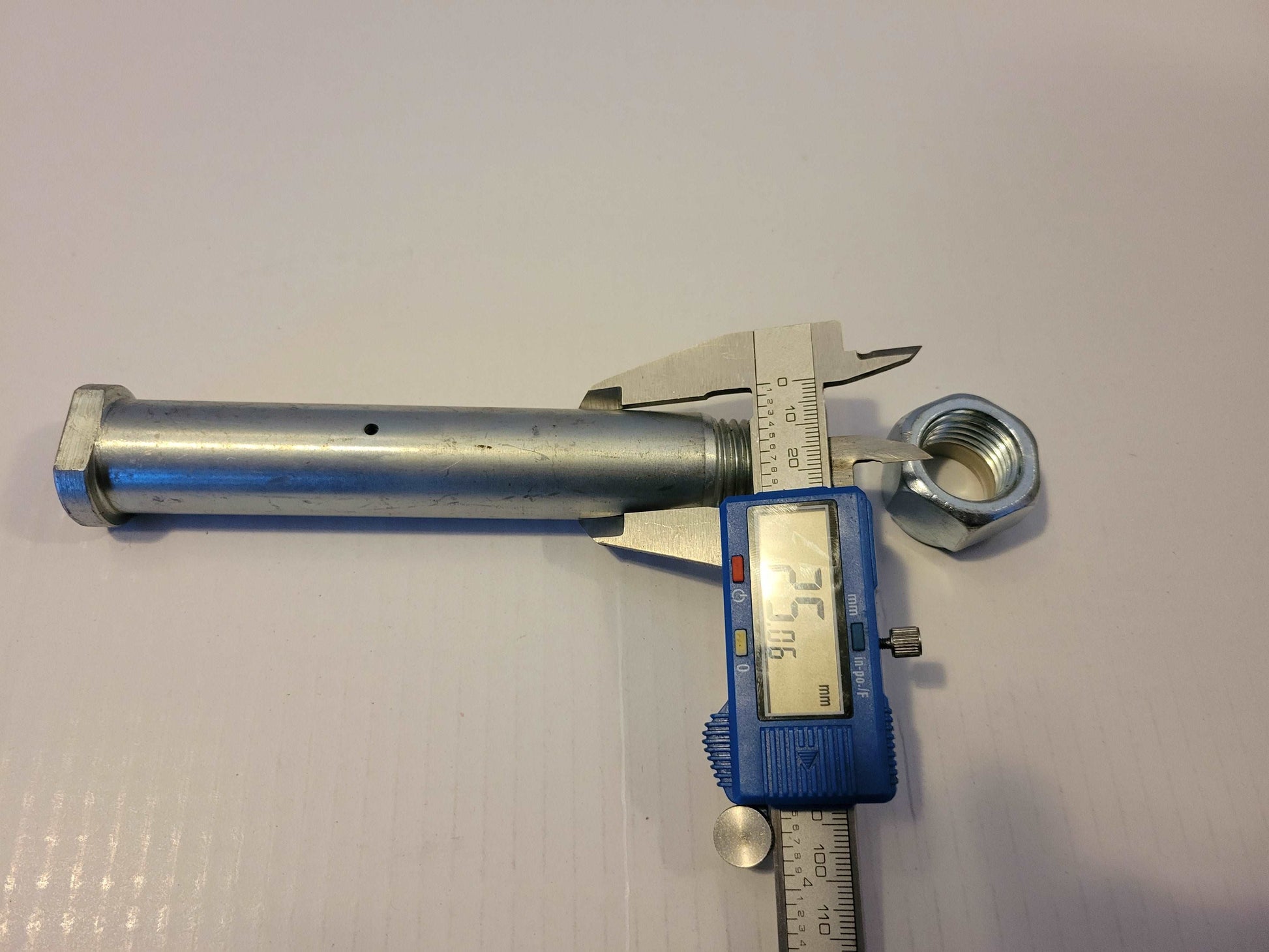 25 millimeter mini excavator bucket pin measured with digital caliper showing exact pin size for Agrotk and FF Industrial replacement parts in Canada