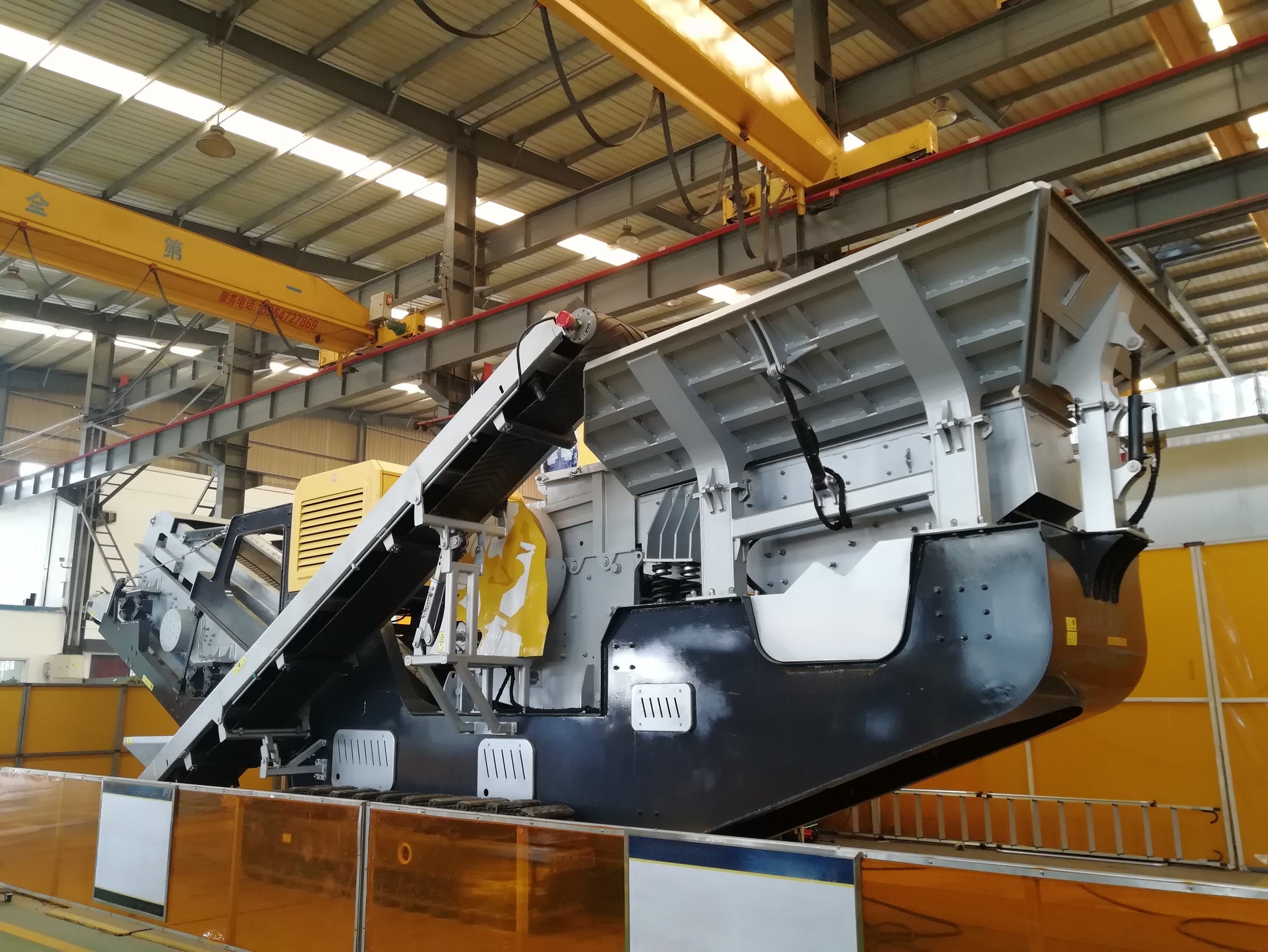 Factory view of JoyT5 JT5JC2 mobile jaw crusher for sale in Canada heavy-duty tracked portable crusher under assembly for mining, construction, and primary crushing applications.

