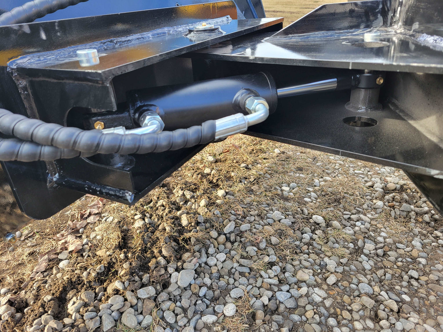 Close-up of hydraulic cylinder and hose connection on JoyT5 JT5SSTM3 tracked mini skid steer 23 HP compact loader for construction and landscaping in Canada