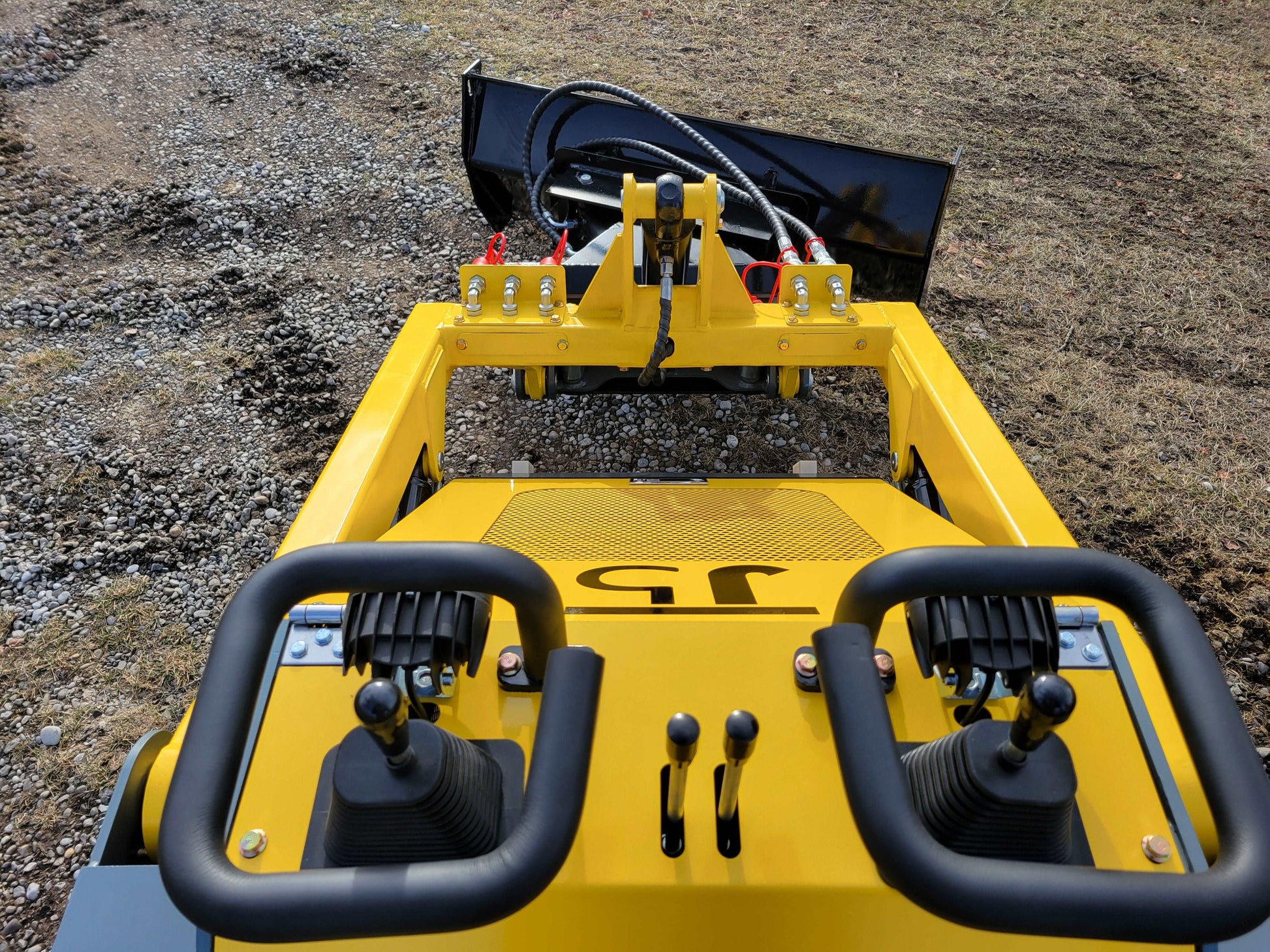 Operator control panel and front view of JoyT5 JT5SSTM3 tracked mini skid steer 23 HP compact loader with bucket attachment for construction and landscaping in Canada

