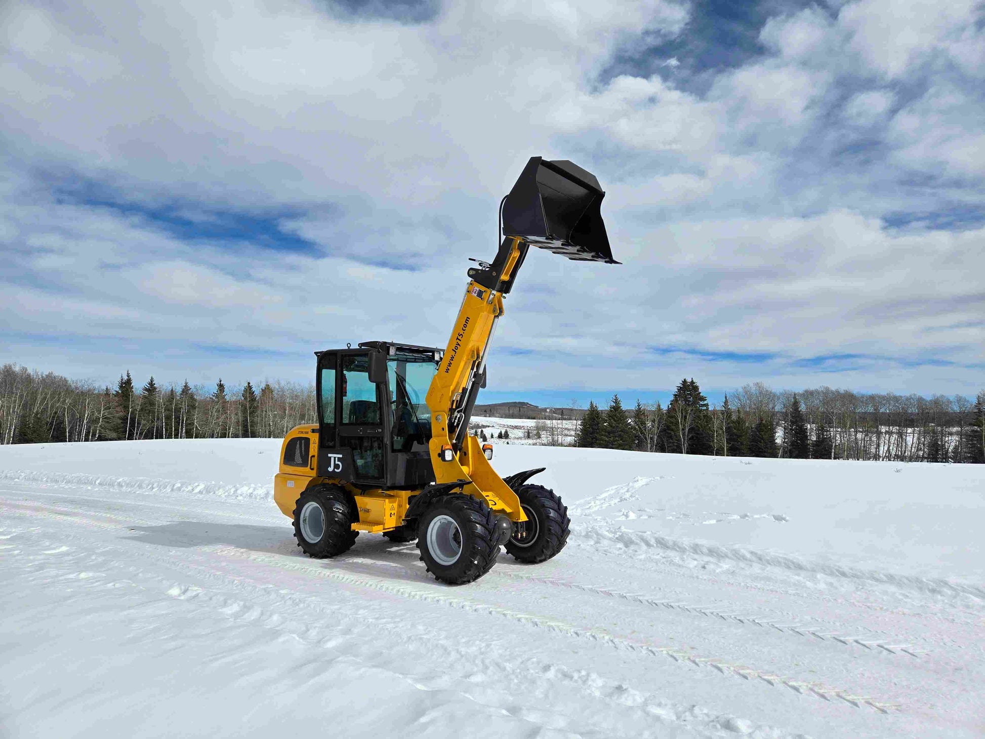 JT5WL1000 compact wheel loader 1 ton 2200 lbs front side view with bucket raised on snow field