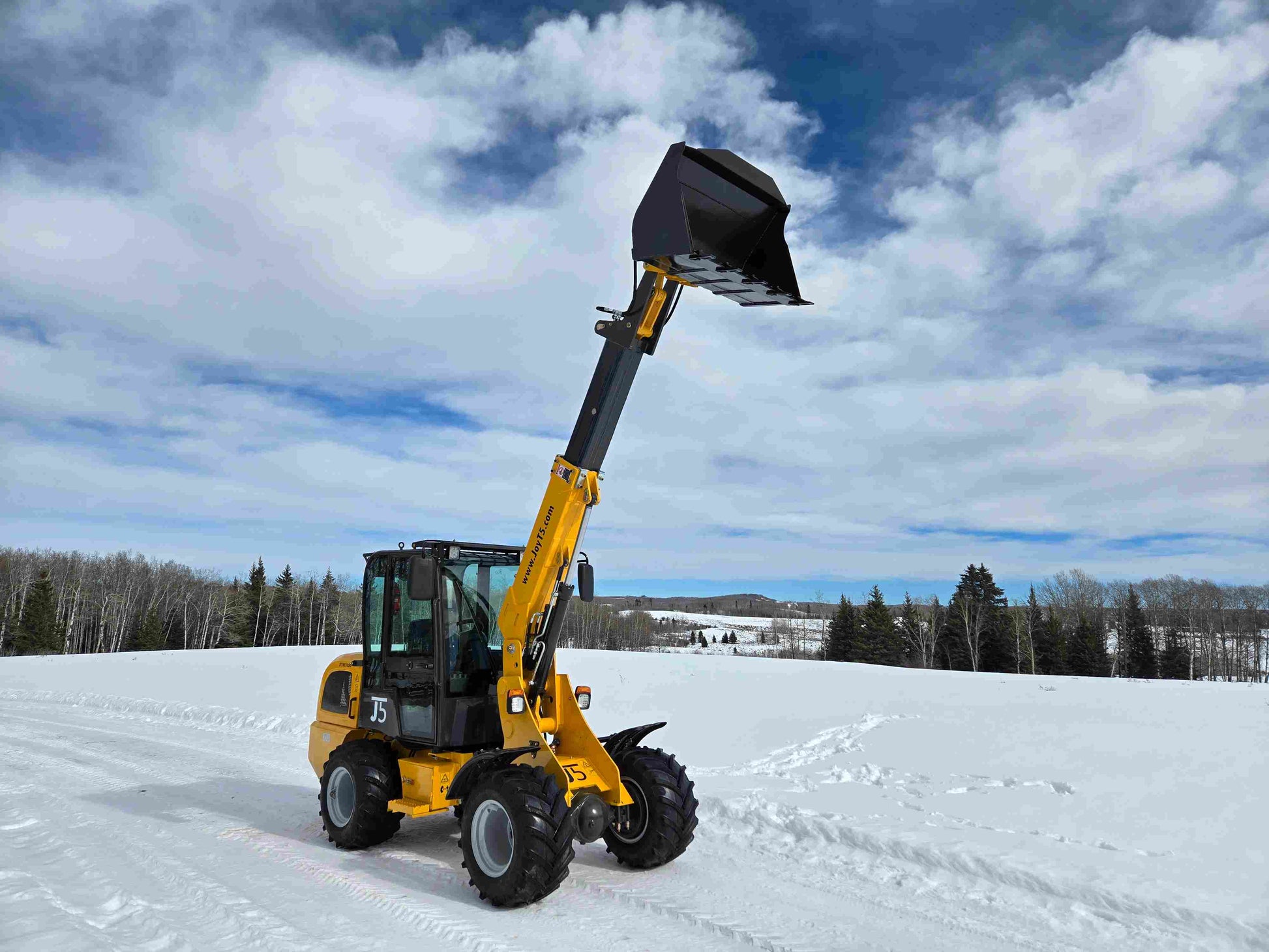 JT5WL1000 compact wheel loader 1 ton 2200 lbs front side angled view with telescopic boom extended and raised bucket in snowy landscape