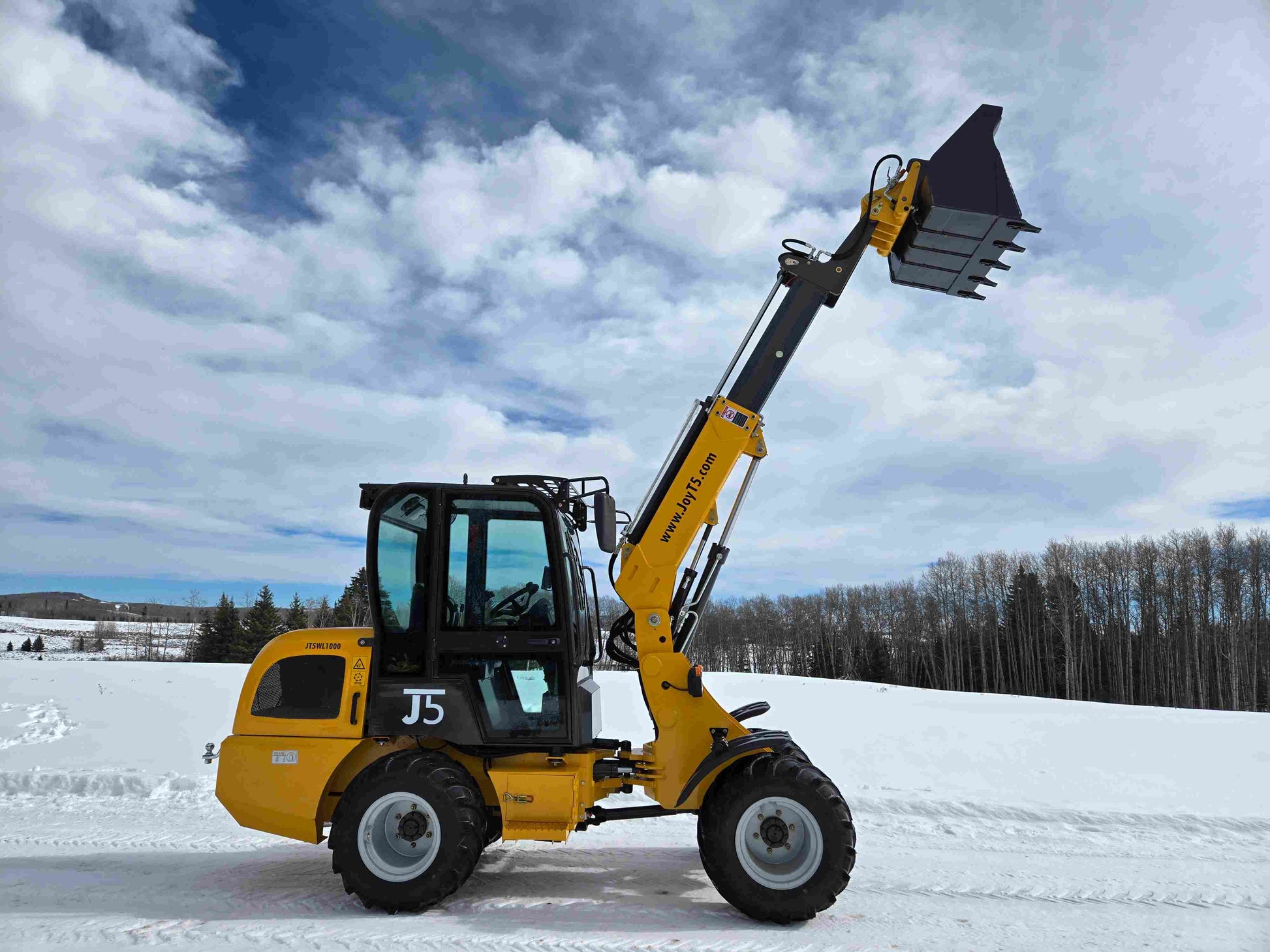 JT5WL1000 compact wheel loader 1 ton 2200 lbs full side view with extended boom and raised bucket in snowy field