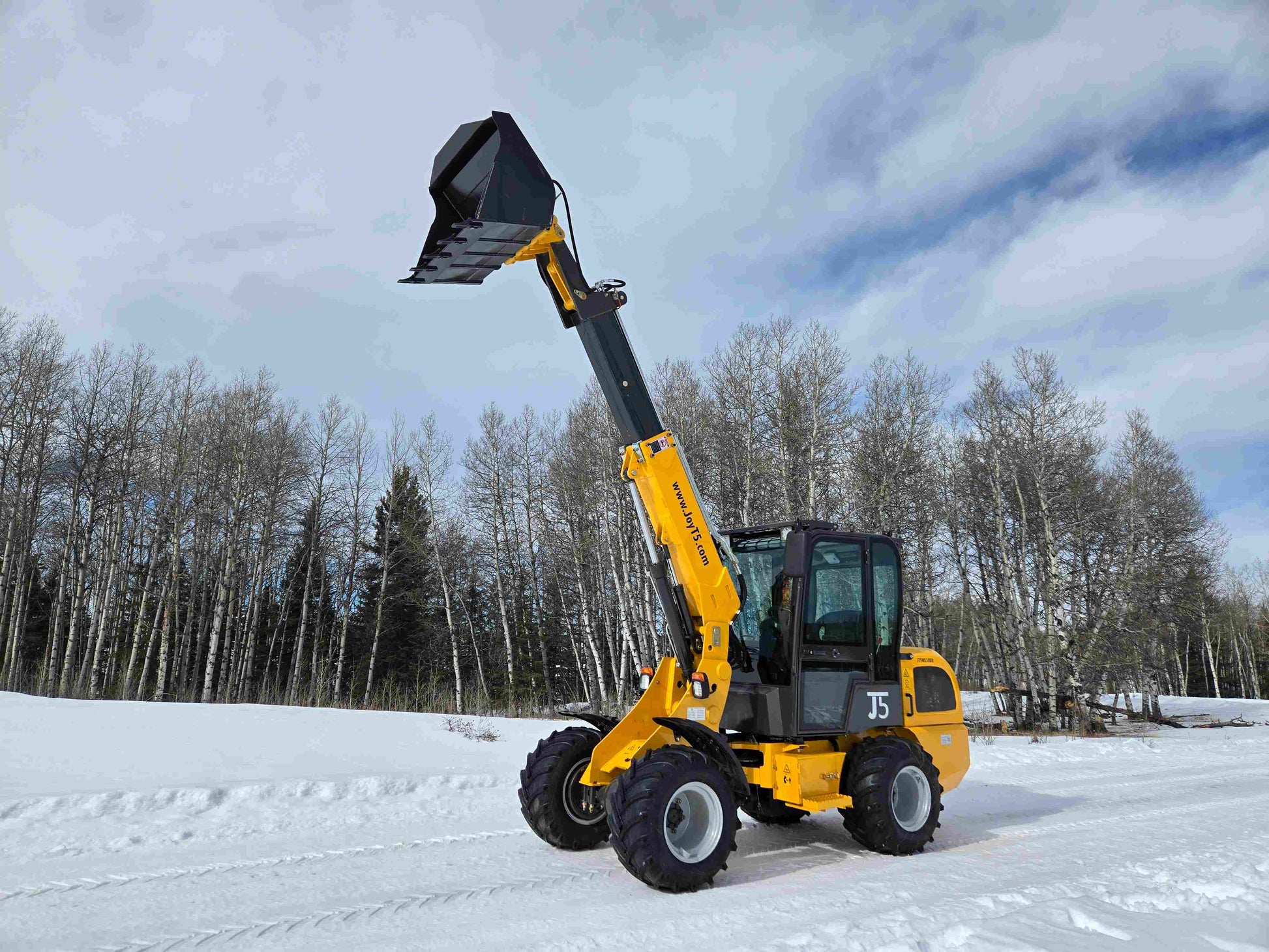 JT5WL1000 compact wheel loader 1 ton 2200 lbs side angle view with telescopic boom extended and open bucket in snowy field.