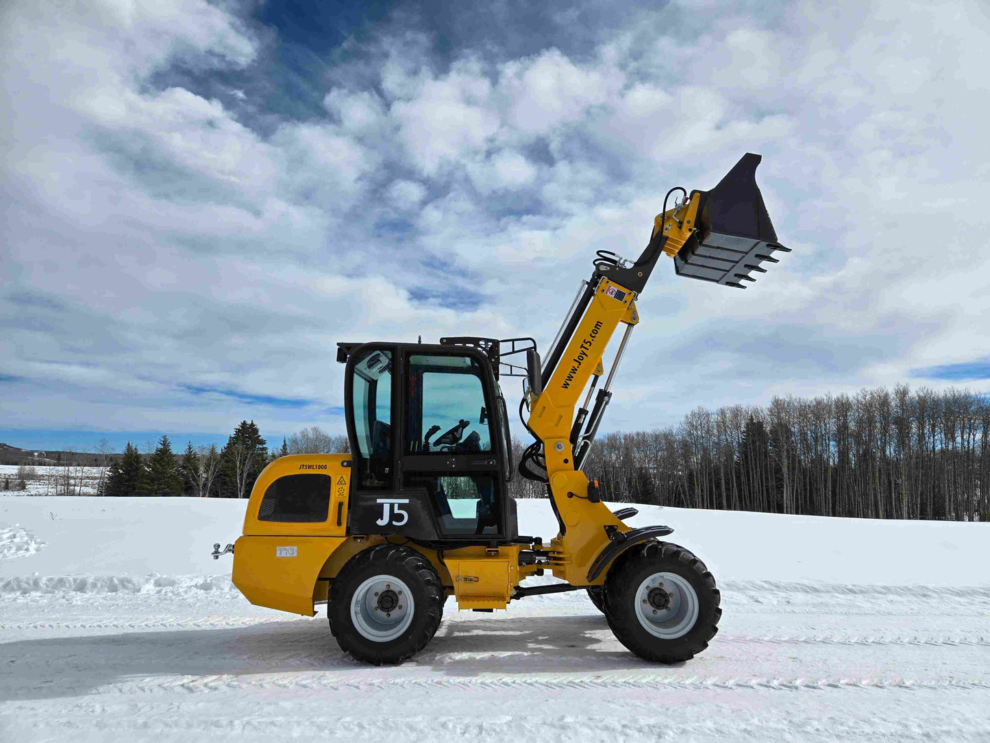 JT5WL1000 compact wheel loader 1 ton 2200 lbs side view with raised bucket on snow field