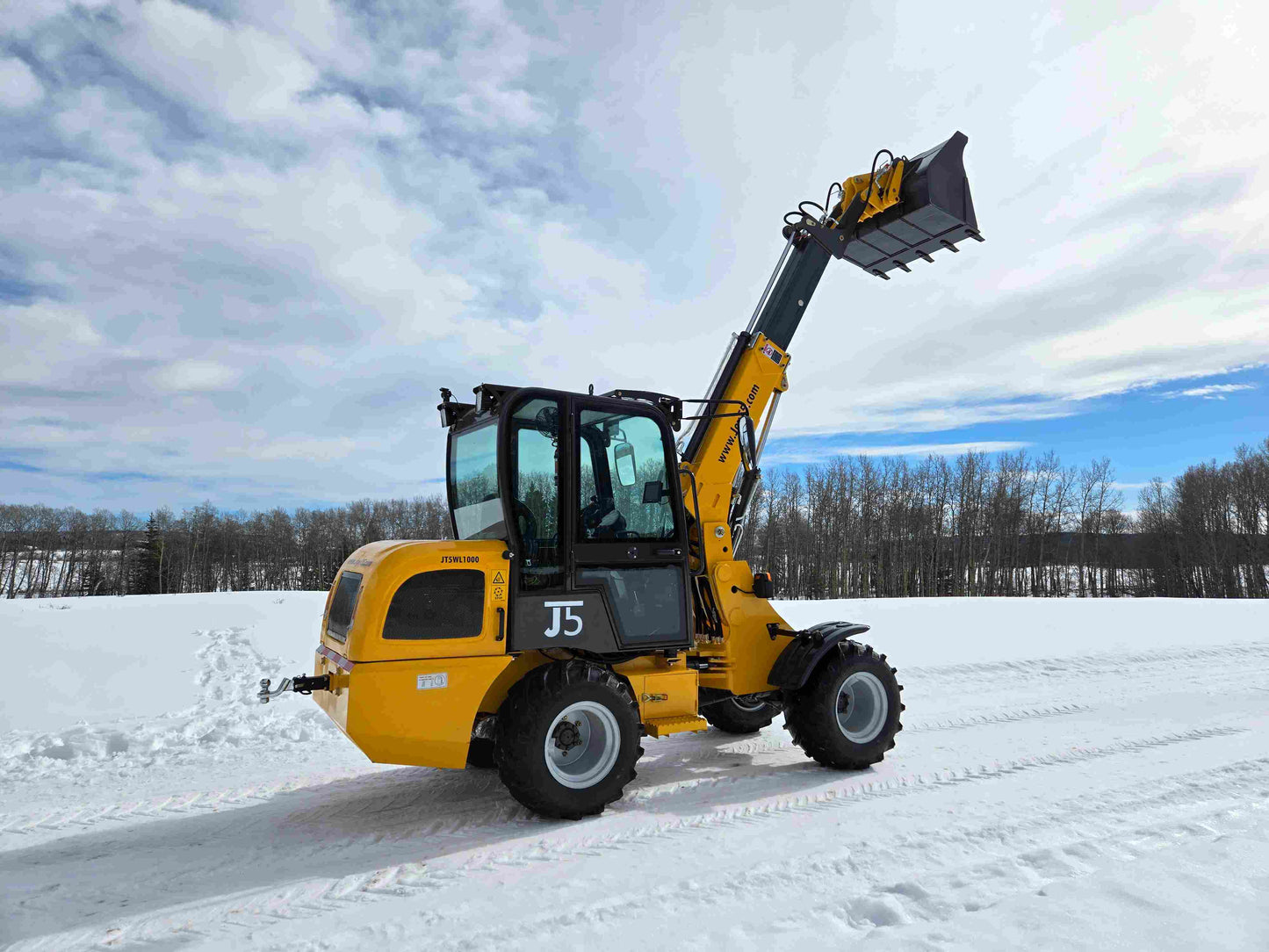 JT5WL1000 compact wheel loader 1 ton 2200 lbs side view on snowy field with raised bucket