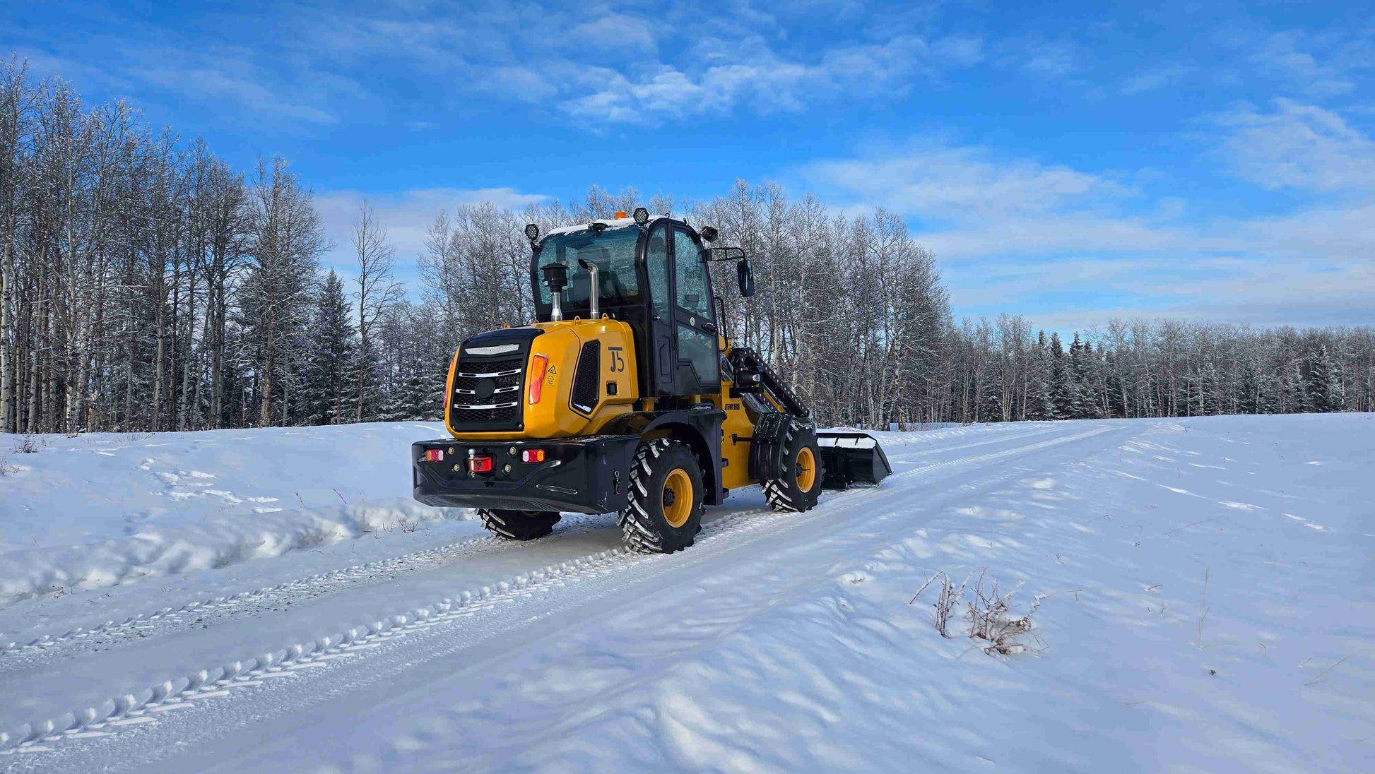 JT5WL1500 compact wheel loader 1.5 ton 3300 lbs rear view on snowy road in Canada – heavy duty small loader for sale.
