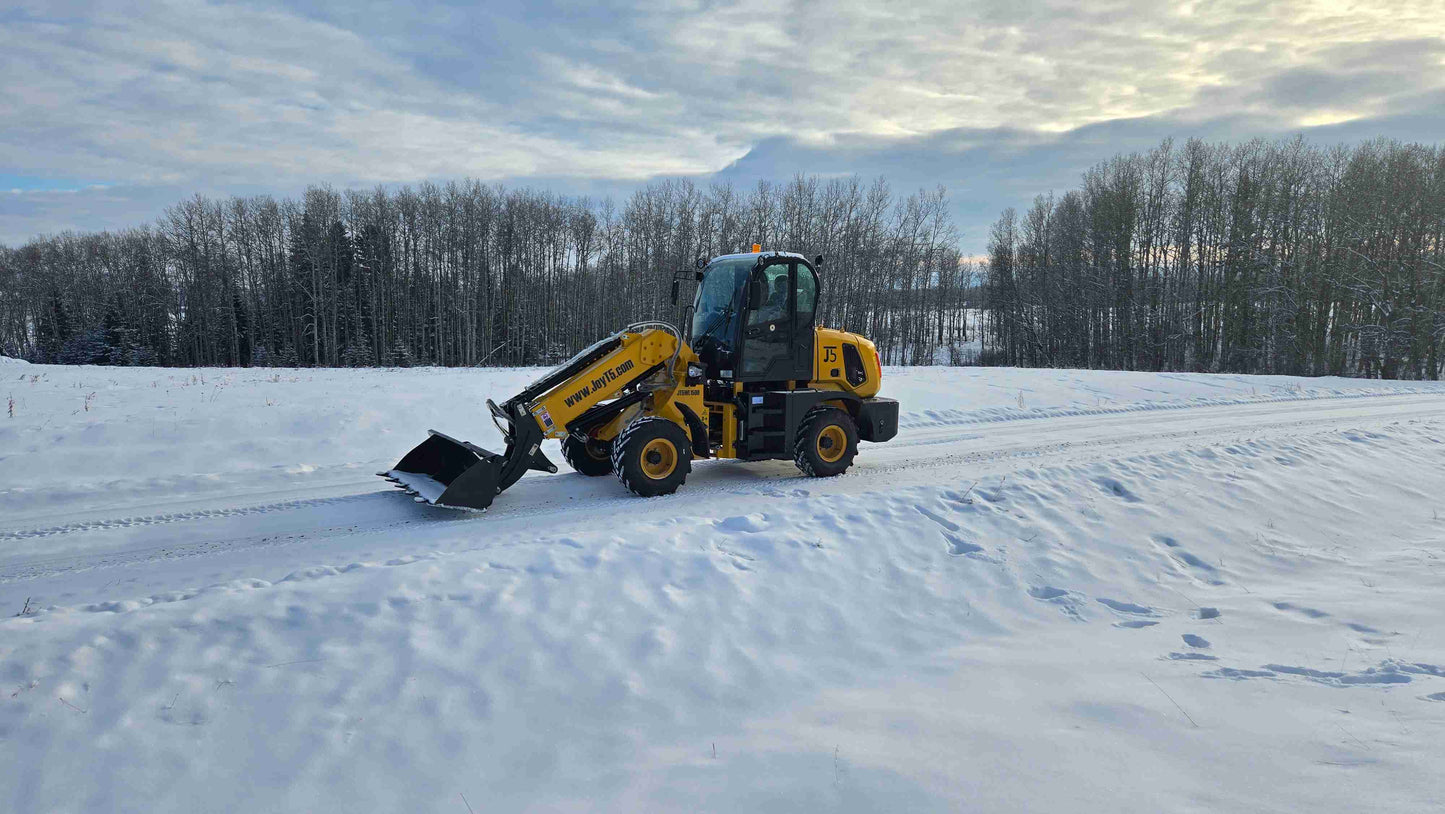 JT5WL1500 compact wheel loader 1.5 ton 3300 lbs clearing snow in Canada – durable small loader with bucket for construction and landscaping.