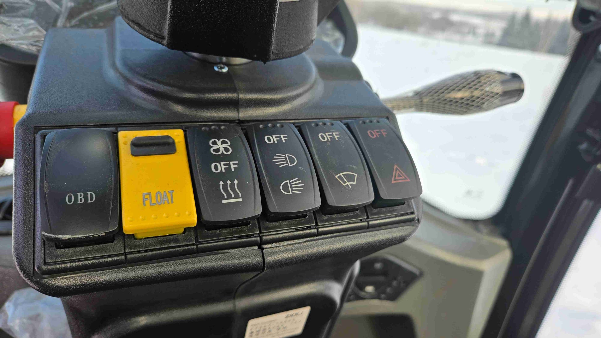 JT5WL1500 compact wheel loader 1.5 ton control panel switches close-up – advanced OBD, float, lights, and heating system for construction in Canada.