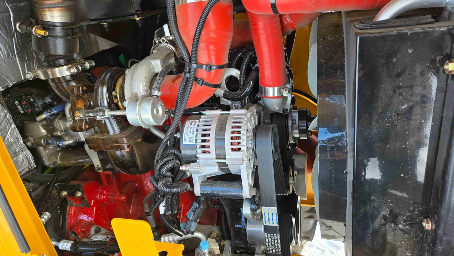 Engine bay of the JT5WL1500 wheel loader showing turbocharger, alternator, and intercooler hoses.