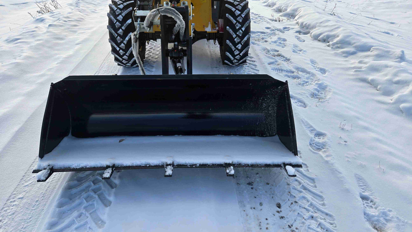 Front close-up view of JT5WL1500 wheel loader bucket on snow-covered ground.