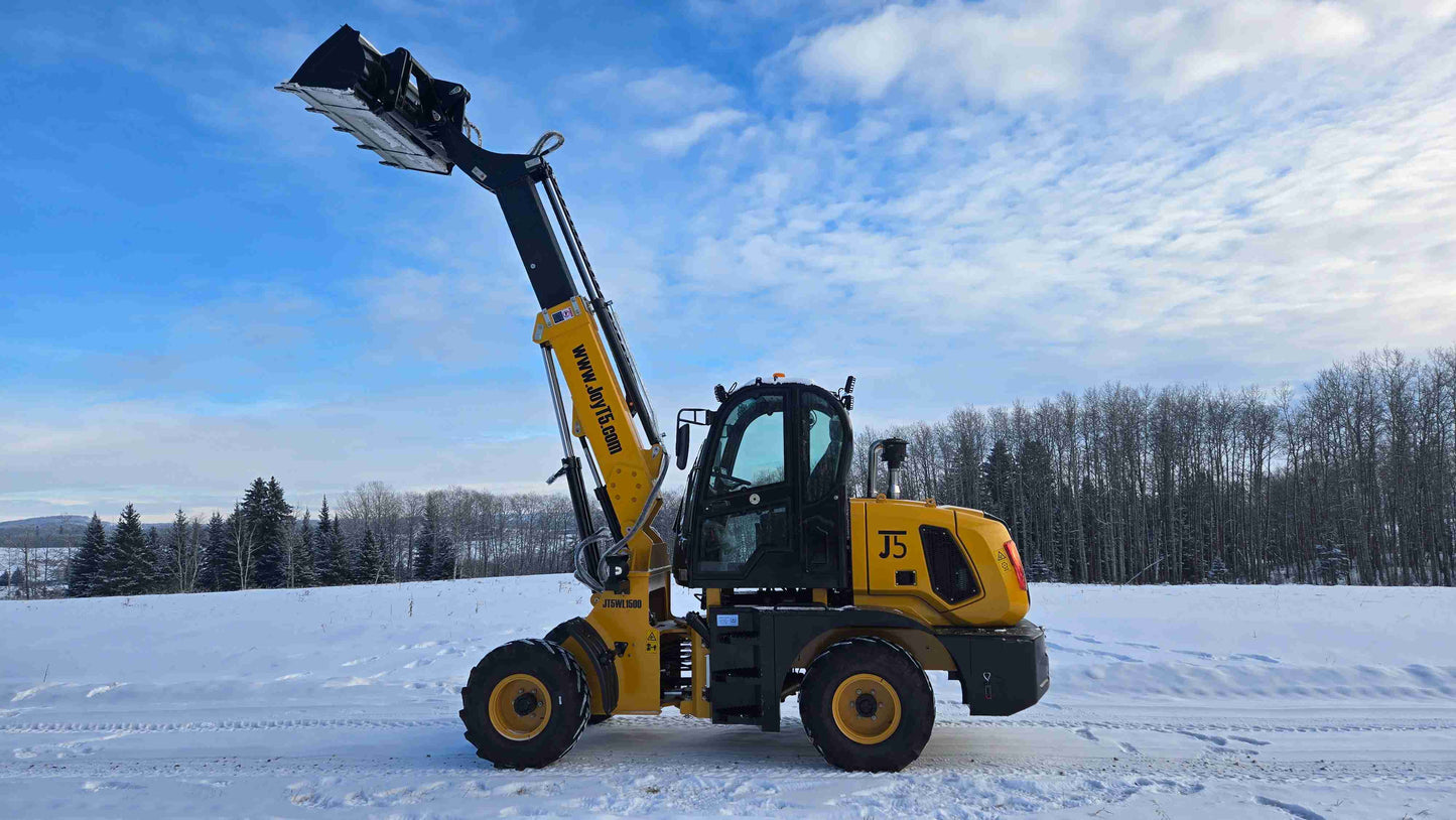 JT5WL1500 wheel loader side profile with raised boom and bucket in a snowy field.