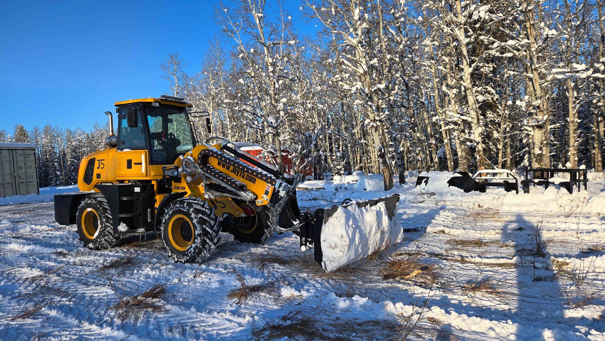 JT5WL2500 2.5 Ton Mini Compact Wheel Loader in Canada plowing snow, durable machine for construction, agriculture, and heavy-duty use.