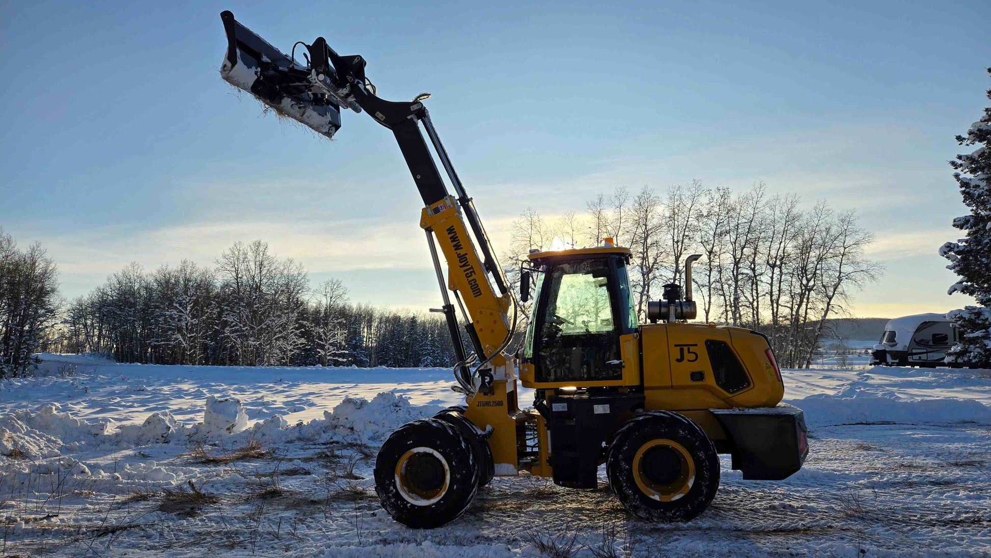 JT5WL2500 compact wheel loader lifting snow high in Canada, durable mini loader for construction and winter clearing
