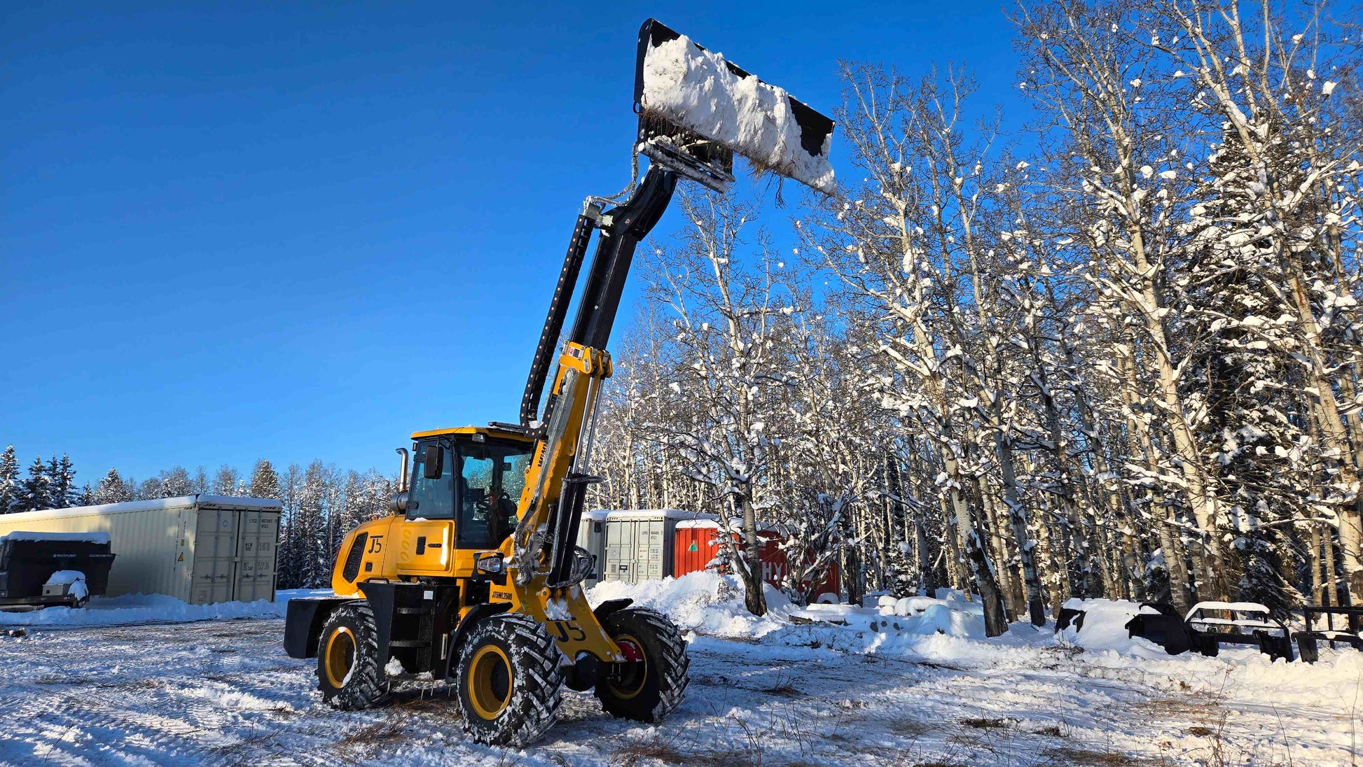 JT5WL2500 compact wheel loader lifting snow with extended boom, durable equipment for snow removal in Canada.