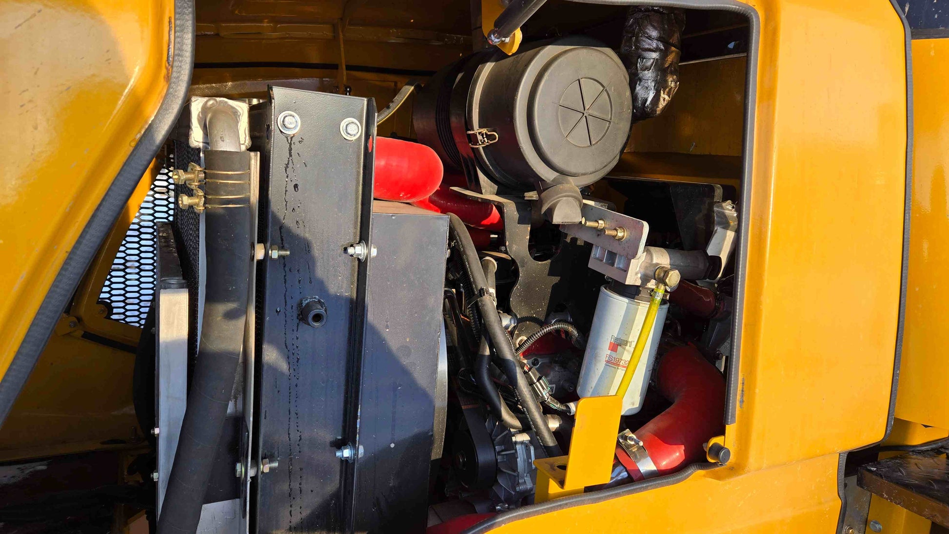 JT5WL2500 wheel loader engine compartment showing radiator, fuel filter, and cooling system components.