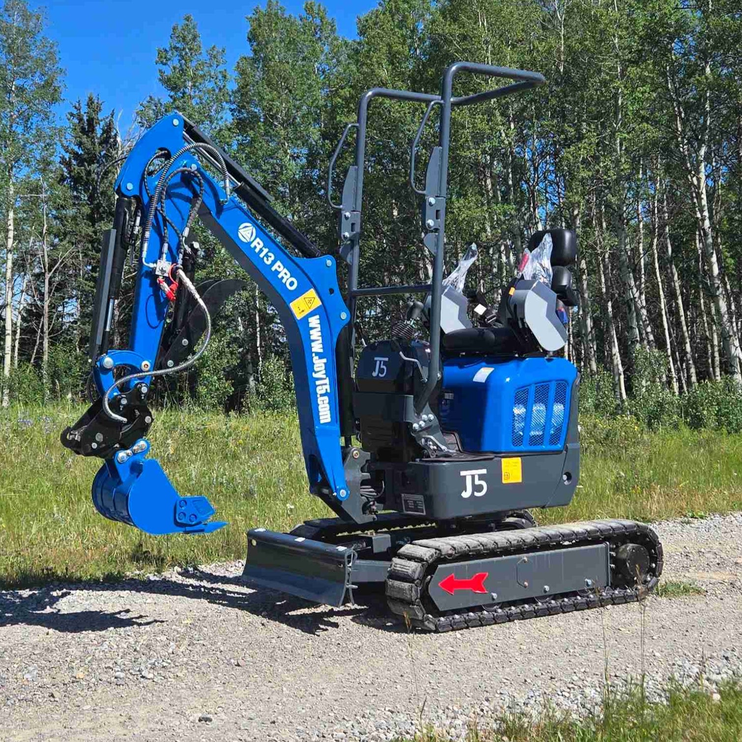 Rippa R13 mini excavator for sale by JoyT5 on a gravel road with trees in the background