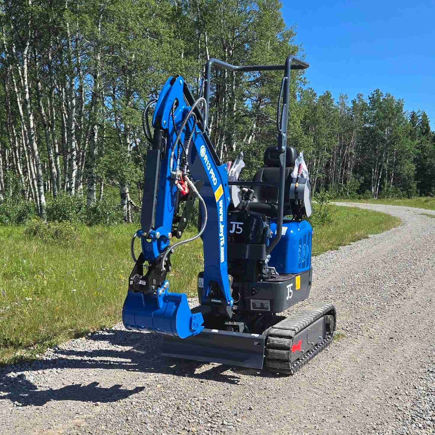 Rippa R13 mini excavator for sale by JoyT5 on a gravel path with trees in the background