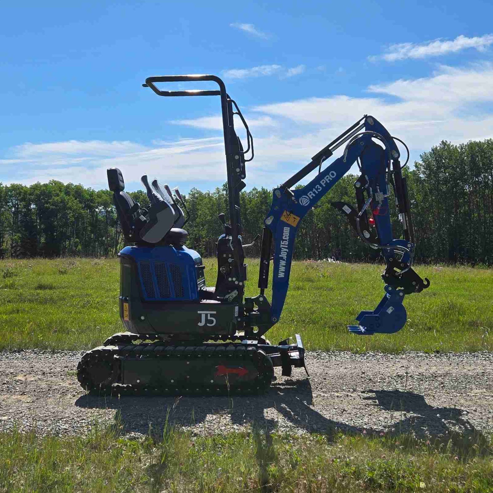 Rippa R13 mini excavator for sale by JoyT5 on a gravel path with a blue sky and trees in the background