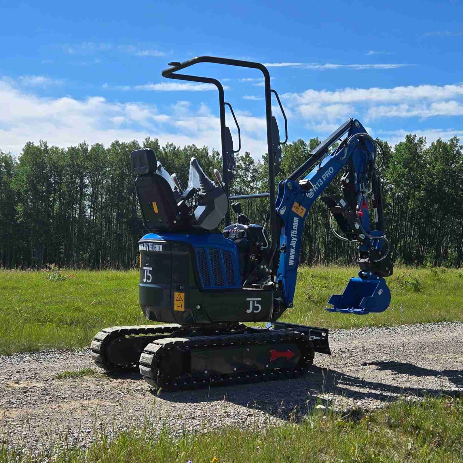 Rippa R13 mini excavator for sale by JoyT5 on a gravel road with trees in the background