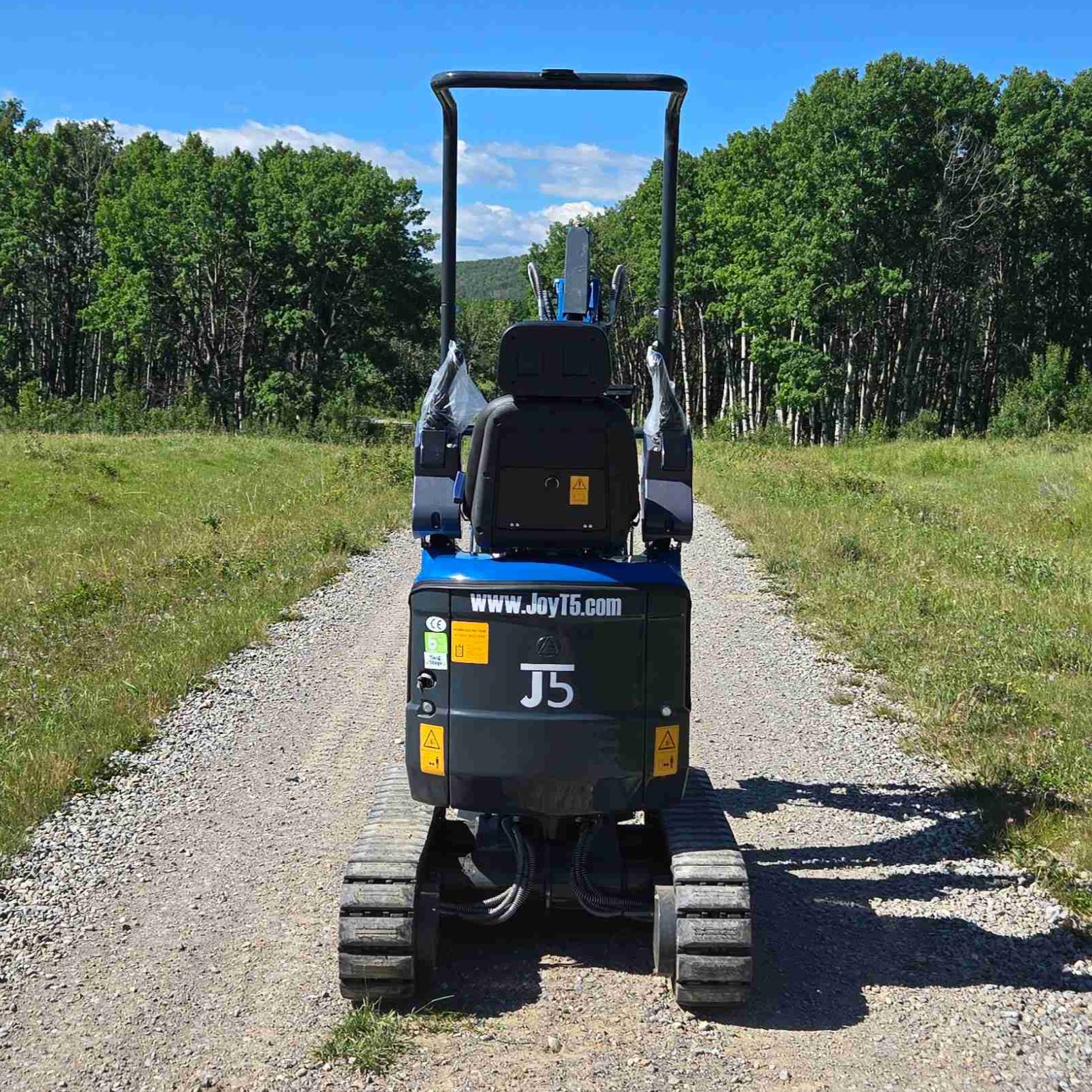Rippa R13 mini excavator for sale by JoyT5 on a gravel path with trees and open sky in the background